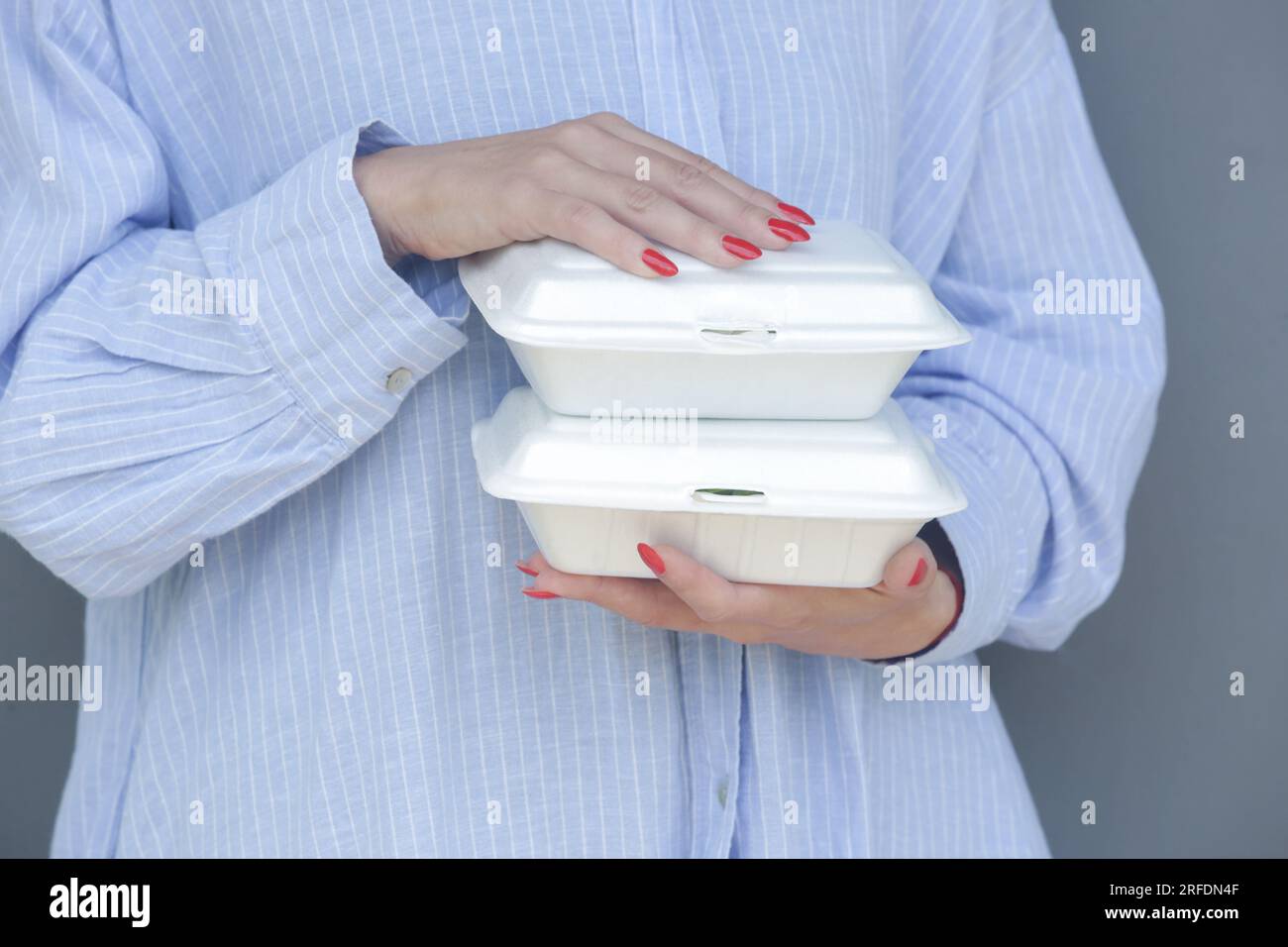Woman's hands holding takeaway foam lunch boxes. Single use food ...
