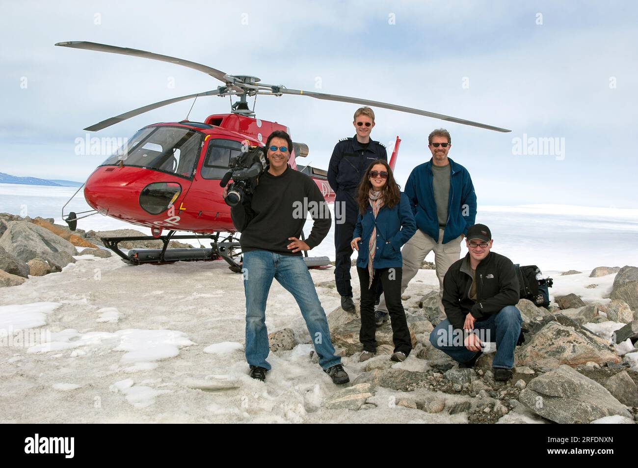 Documentary film crew with helicopter atop ice cap near Nuuk, Greenland Stock Photo