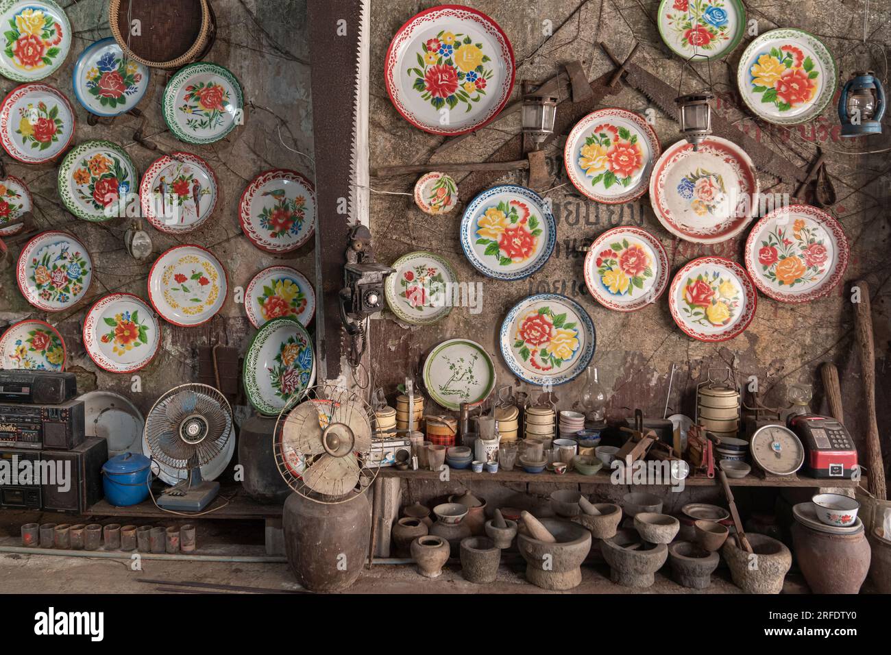 Antique shop in Takua Pa, Thailand. Old Chinese Plates, Mortars, and Household Items. Stock Photo