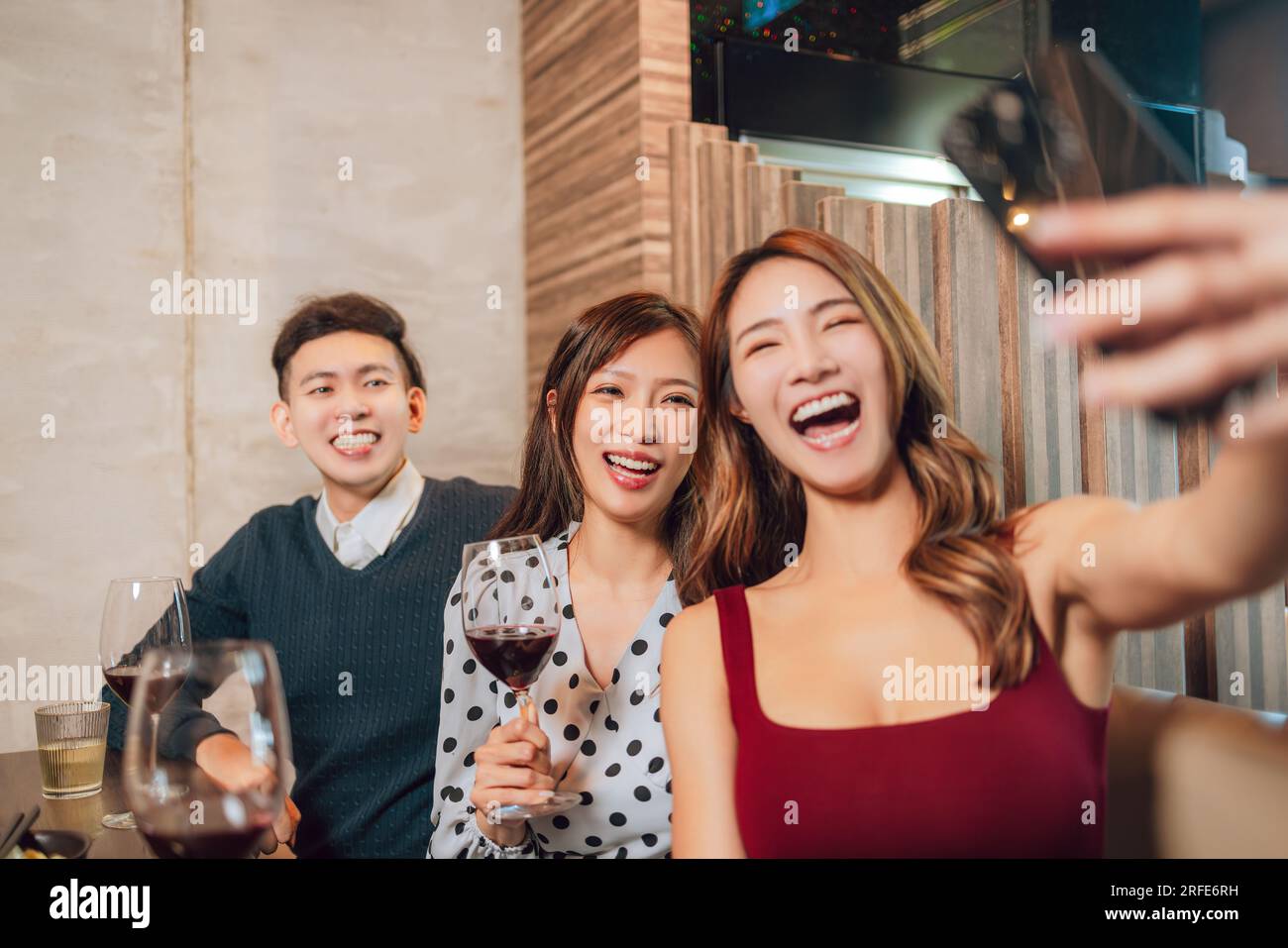 Group Of Friends Taking Selfie During Lunch at restaurant Stock Photo