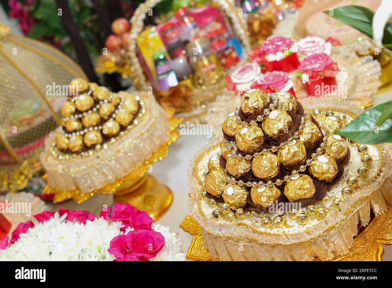 Round chocolate wrapped in gold foil Stock Photo Alamy