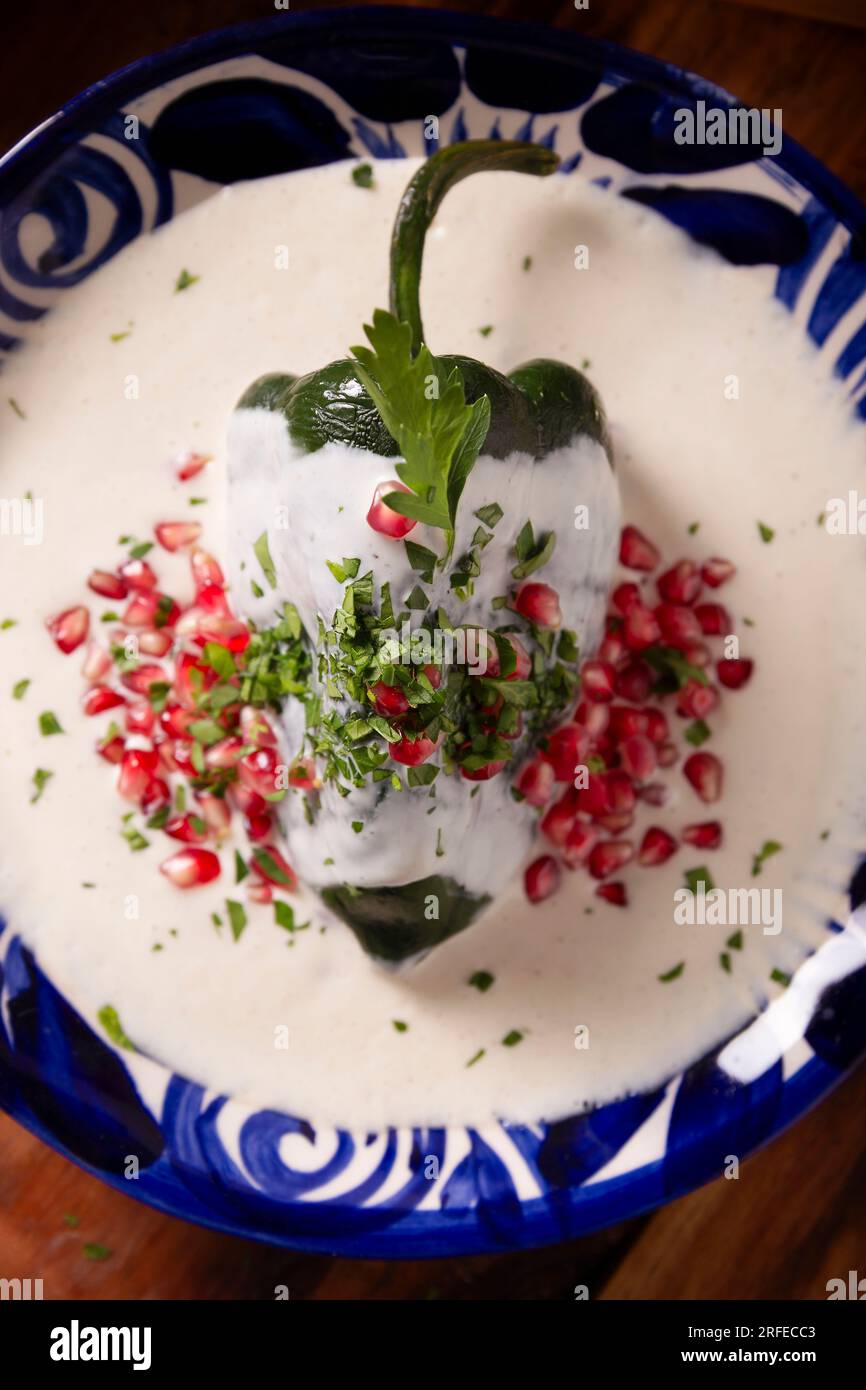 Chile en Nogada, Typical dish from Mexico. Prepared with poblano chili stuffed with meat and fruits and covered with a walnut sauce. Named as the quin Stock Photo