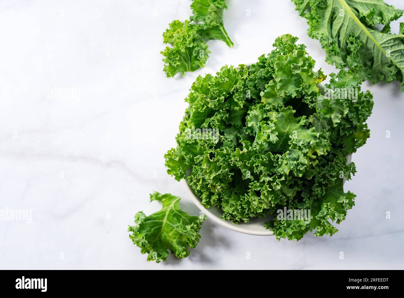 Kale in bowl on marble background. curly kale. View from directly above. Stock Photo