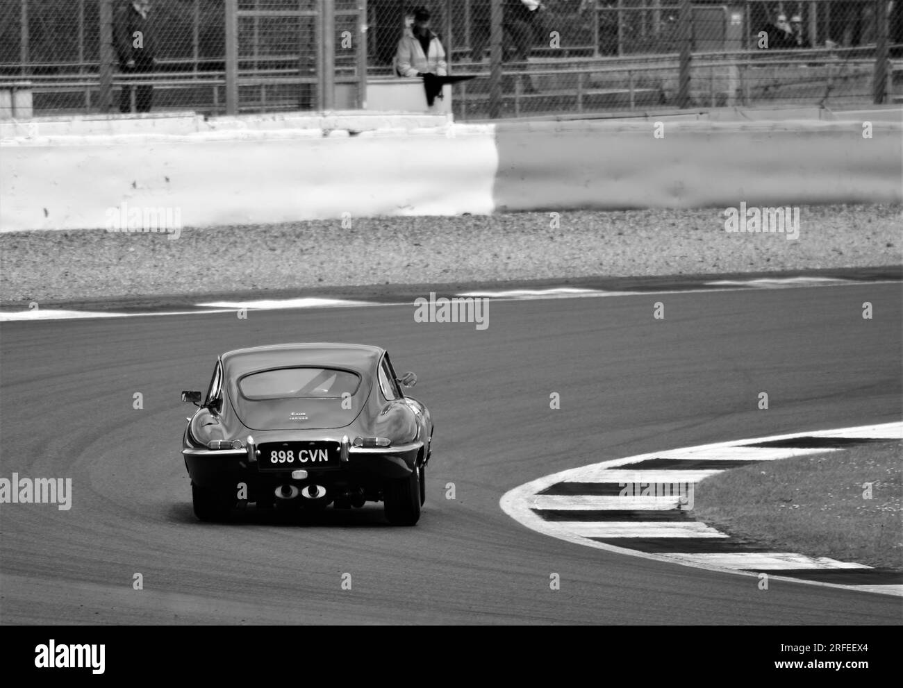 An E-Type Jaguar takes a corner at Silverstone Stock Photo