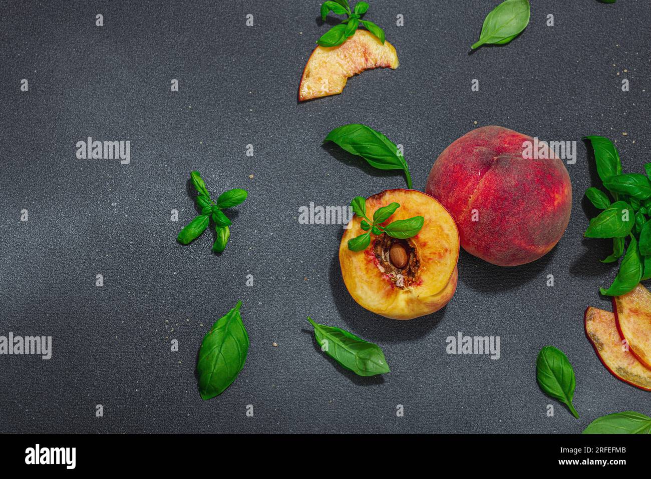Fruit culinary background. Ripe peaches and fresh basil leaves. Modern ...