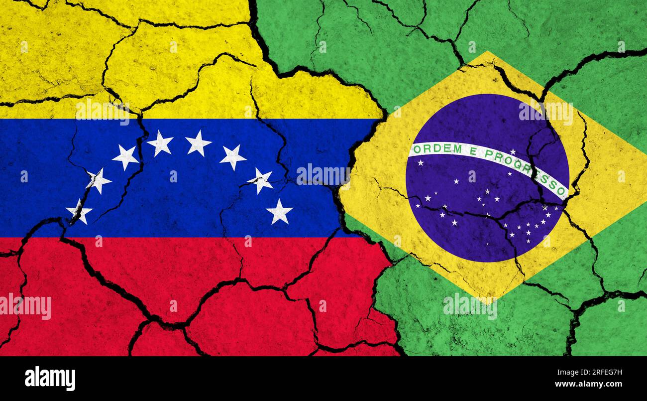 Flags of Venezuela and Brazil on cracked surface - politics, relationship concept Stock Photo