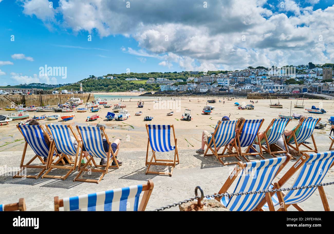 Deckchairs lined up on the seafront at St Ives harbour in Cornwall, UK Stock Photo