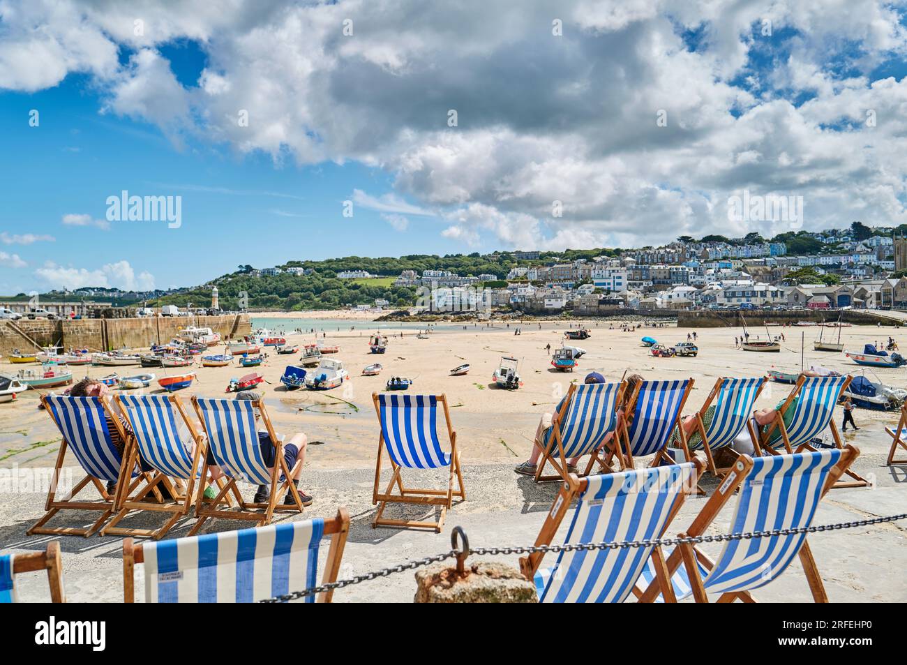 Deckchairs lined up on the seafront at St Ives harbour in Cornwall, UK Stock Photo