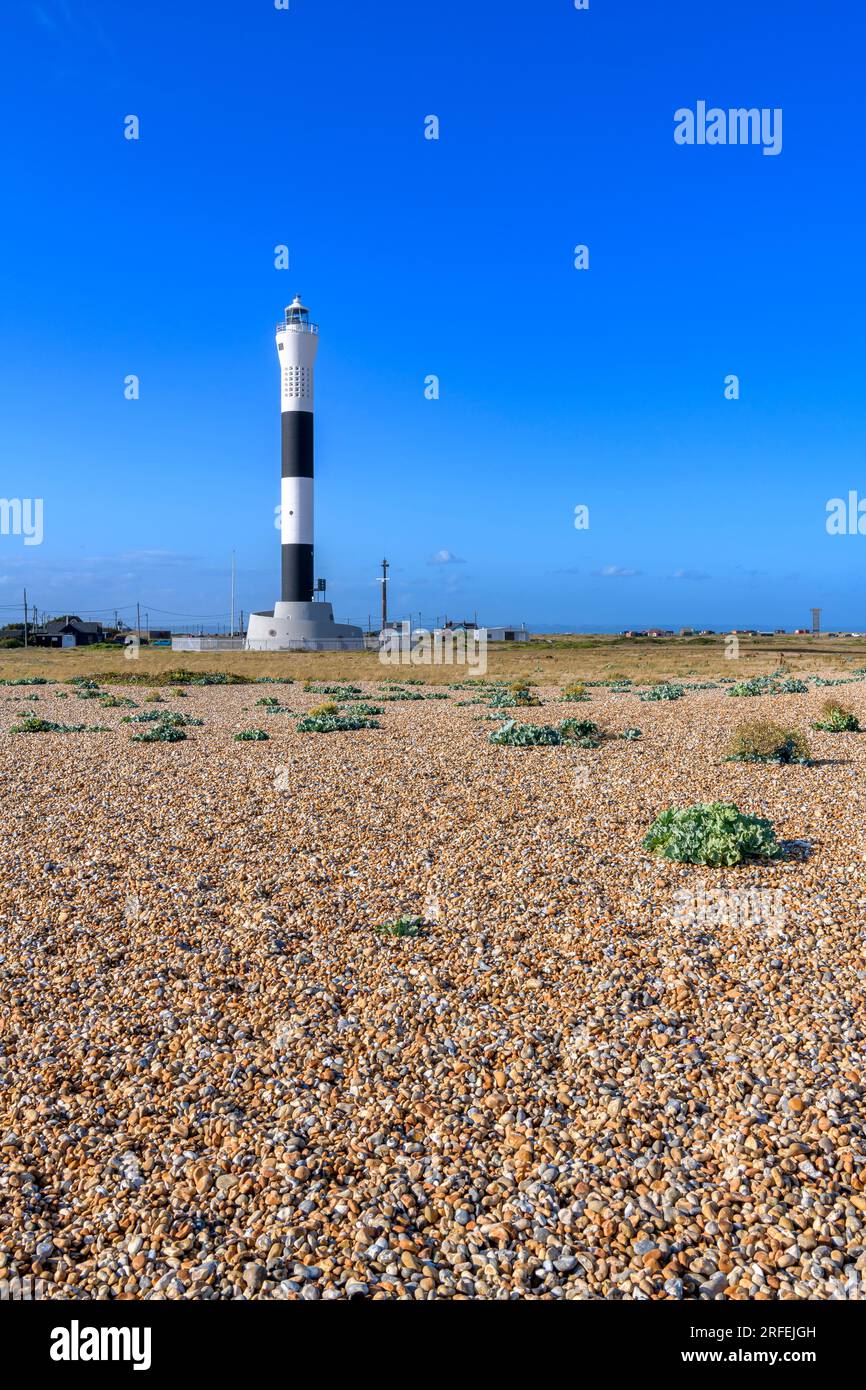 The New Lighthouse on Dungeness beach, the SE UK coast. Miles of desolate shingle beach, isolated black-painted cottages and a power station! Stock Photo