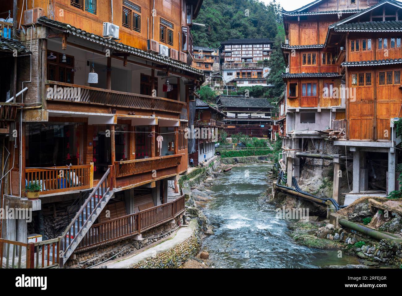 raditional wooden stilt houses (Diaojiaolou) along the river in Xijiang ...