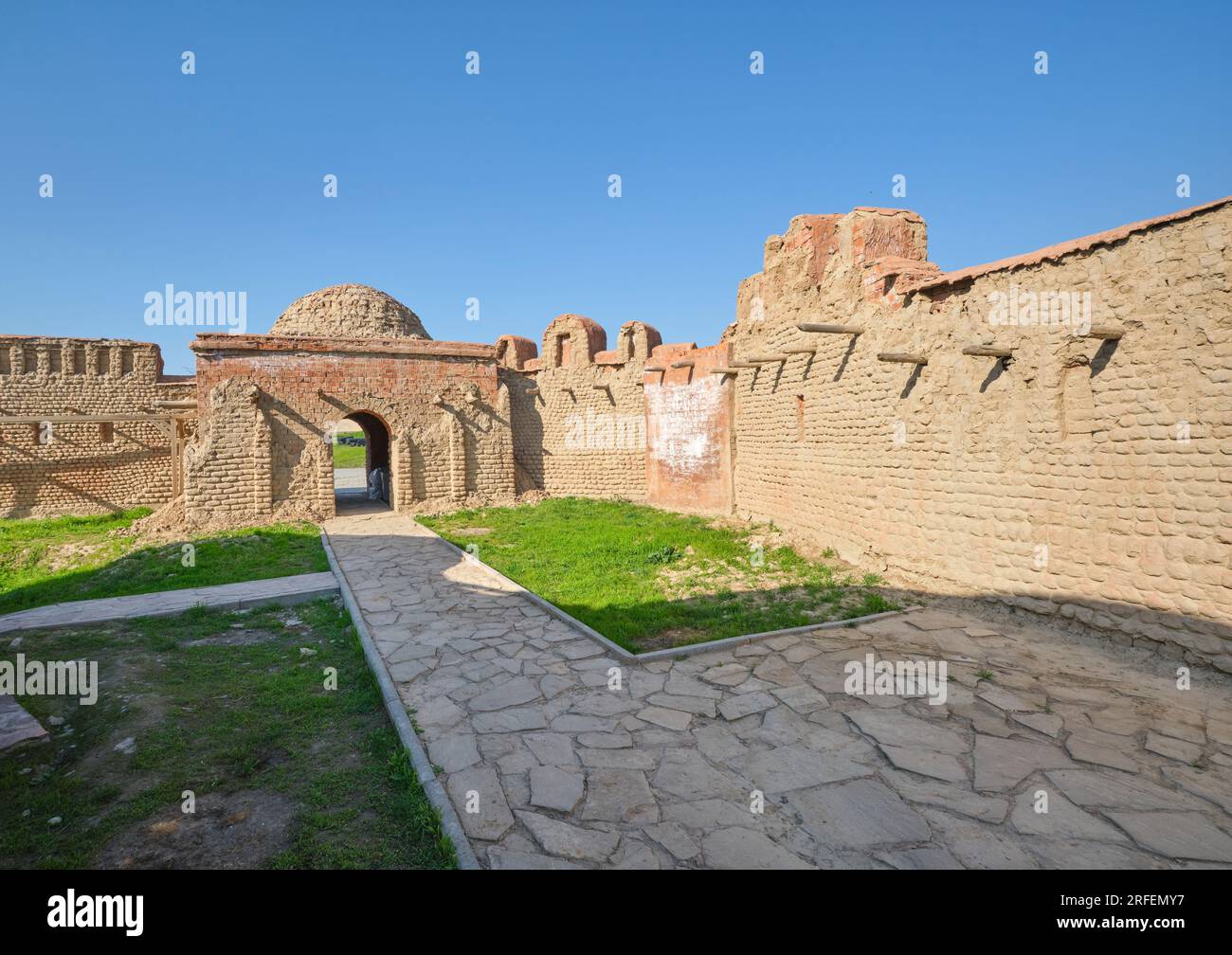 View of a section of old brick wall and an arched gateway. At the old fortress, citadel museum in Shymkent, Kazakhstan. Stock Photo