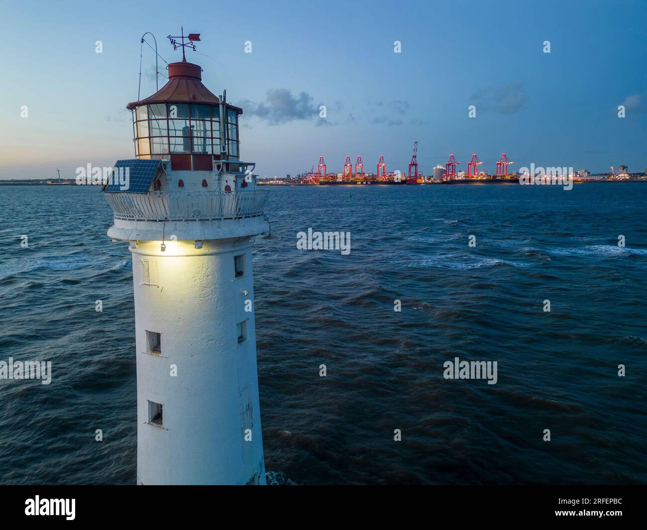 New Brighton lighthouse and Liverpool2 container terminal st dusk ...
