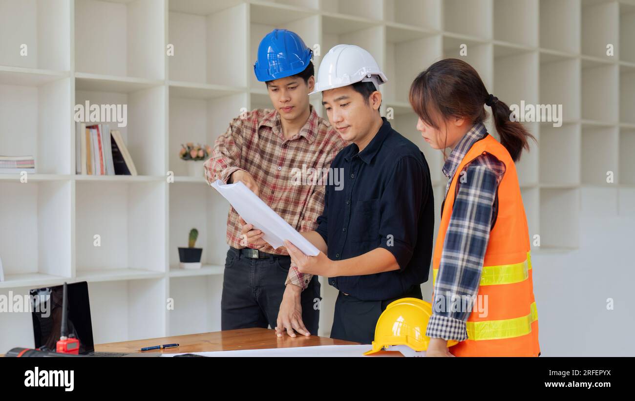 Group of architects and engineers discuss about construction blueprint Stock Photo
