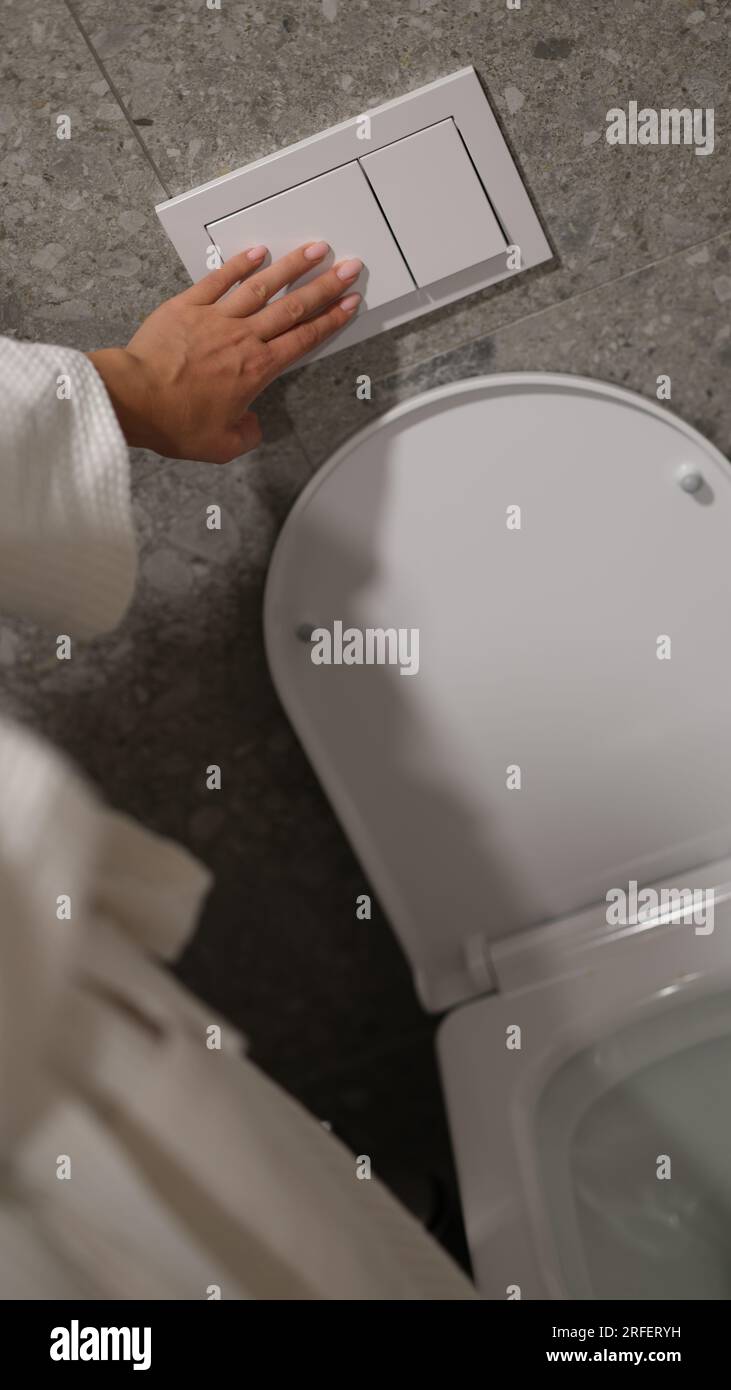 Economical toilet flush press with two separate buttons Stock Photo - Alamy