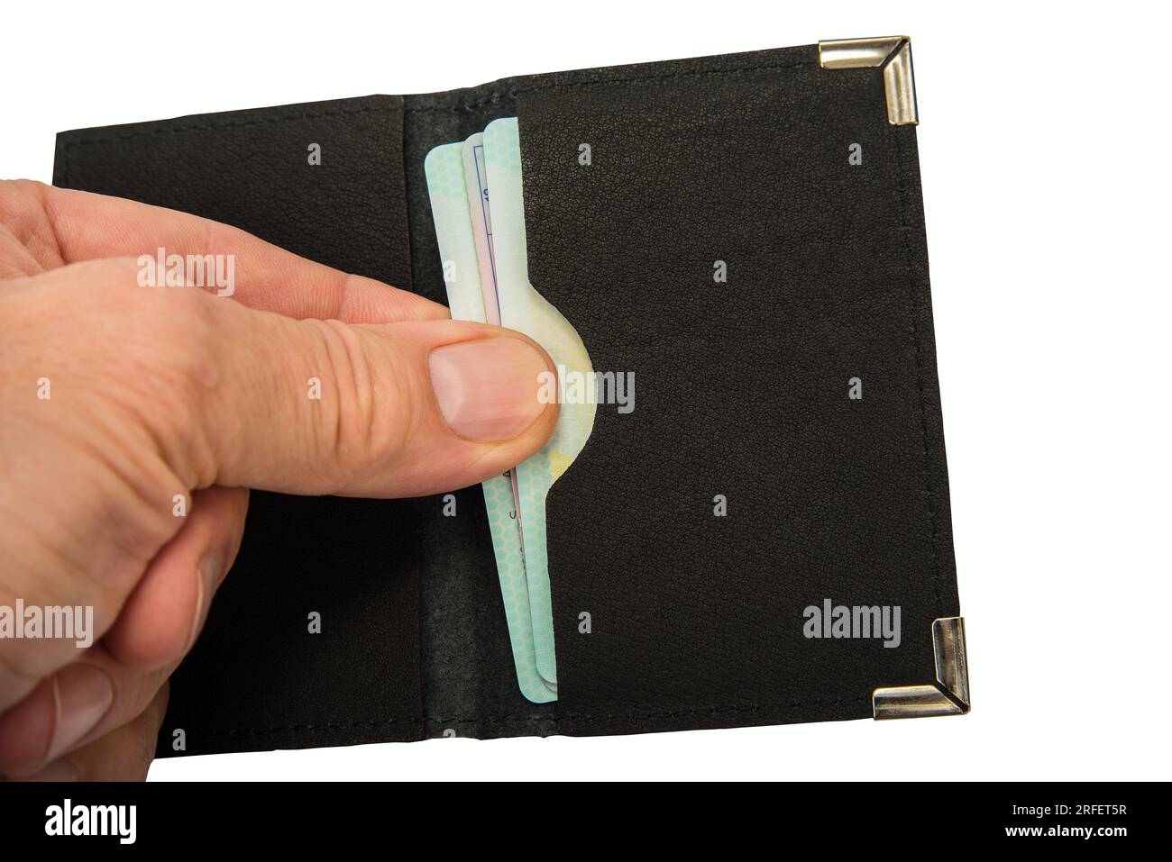 Man pulls out a credit card from a leather case Stock Photo