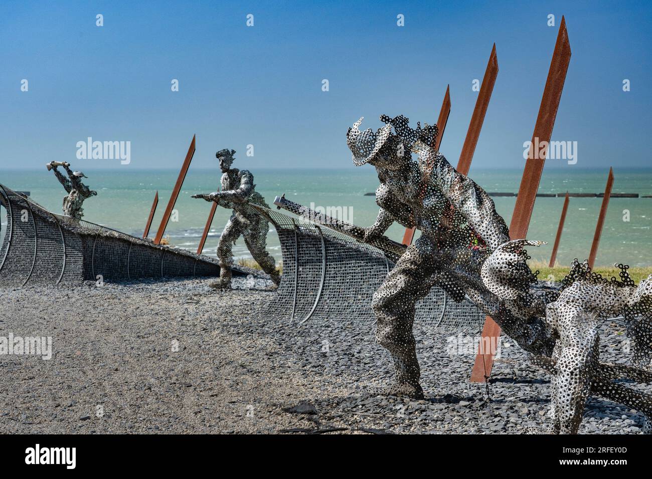 France, Calvados, Arromanches les Bains, Gold Beach, ghostly statues represent the soldiers emerging from the waves after landing the first assault boot on the beach Stock Photo