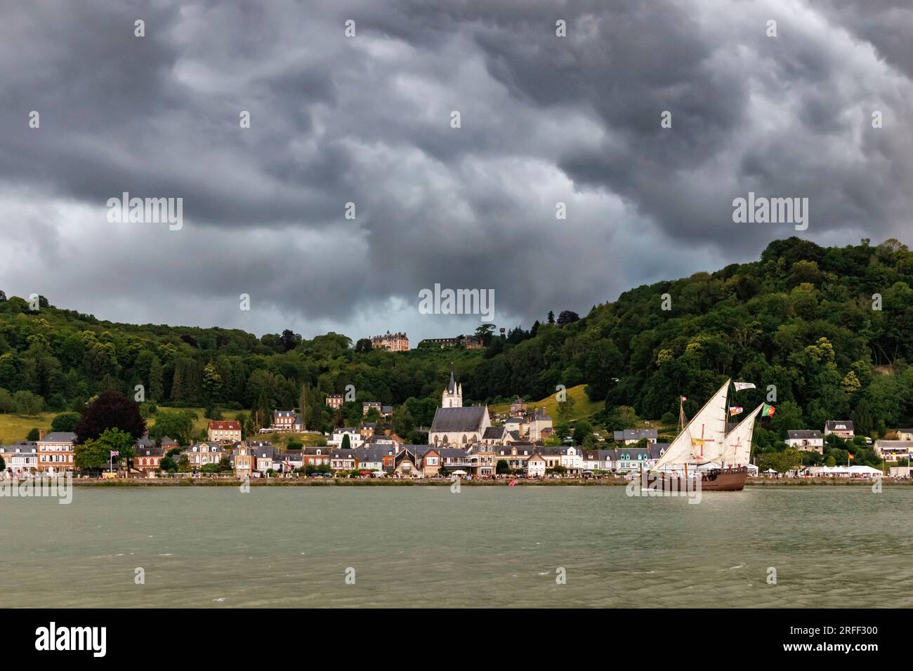 France, Seine-Maritime, Vatteville-la-Rue, Armada 2023, Grand Parade, caravel Vera Cruz sails in front of Villequier village, under a threatening stormy sky Stock Photo