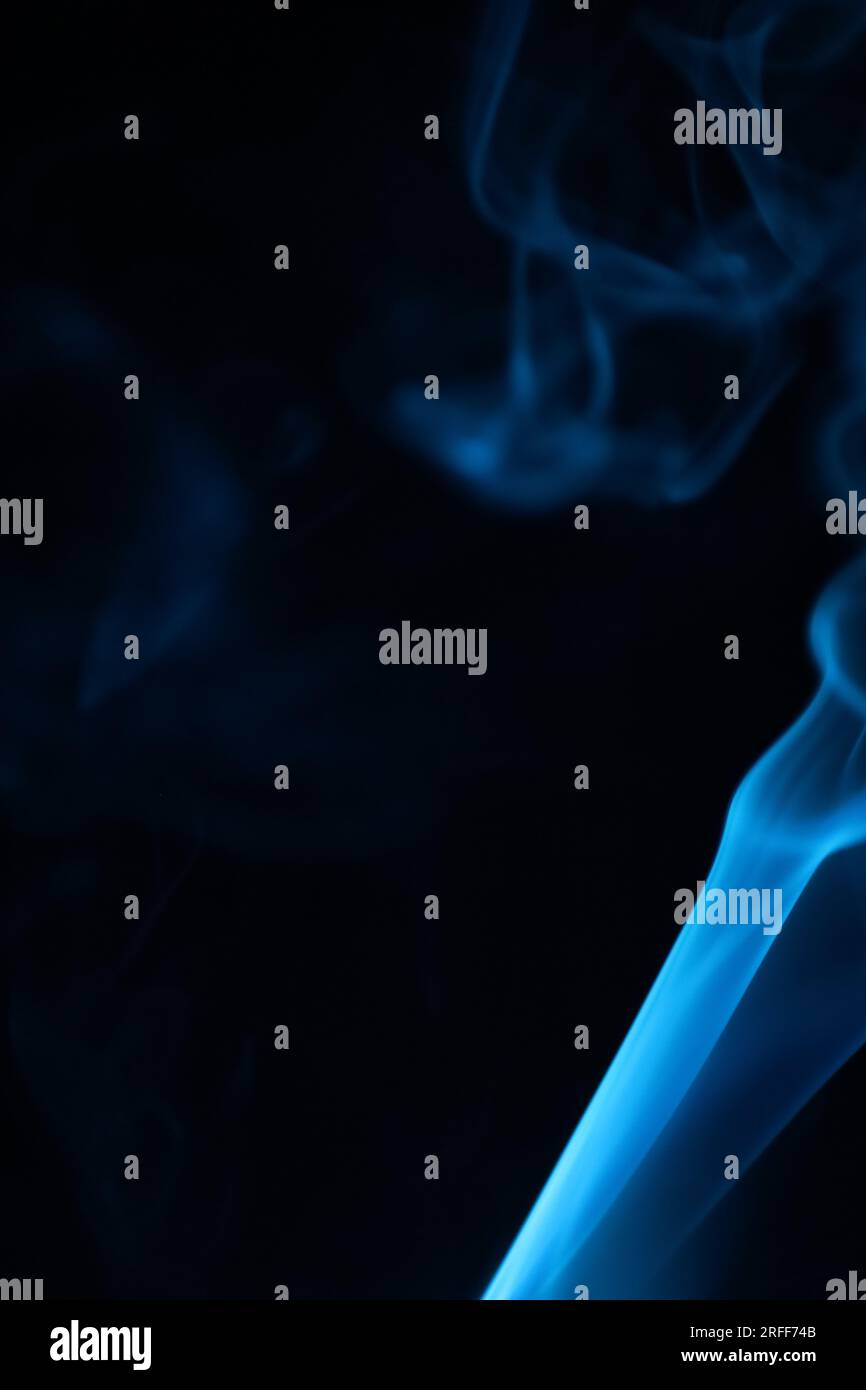 Blue smoke on a dark background, patterns, vertical Stock Photo - Alamy