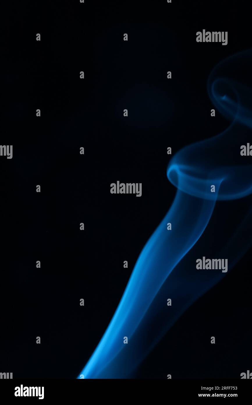 Blue smoke on a dark background, patterns, vertical Stock Photo - Alamy