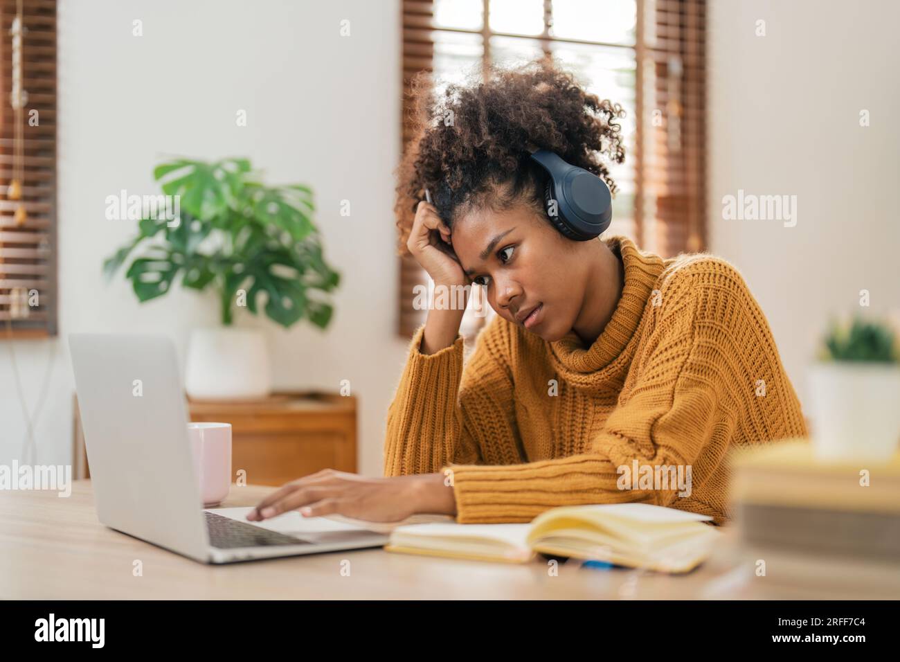 Tired curly African American woman bored with of laptop sad and ...
