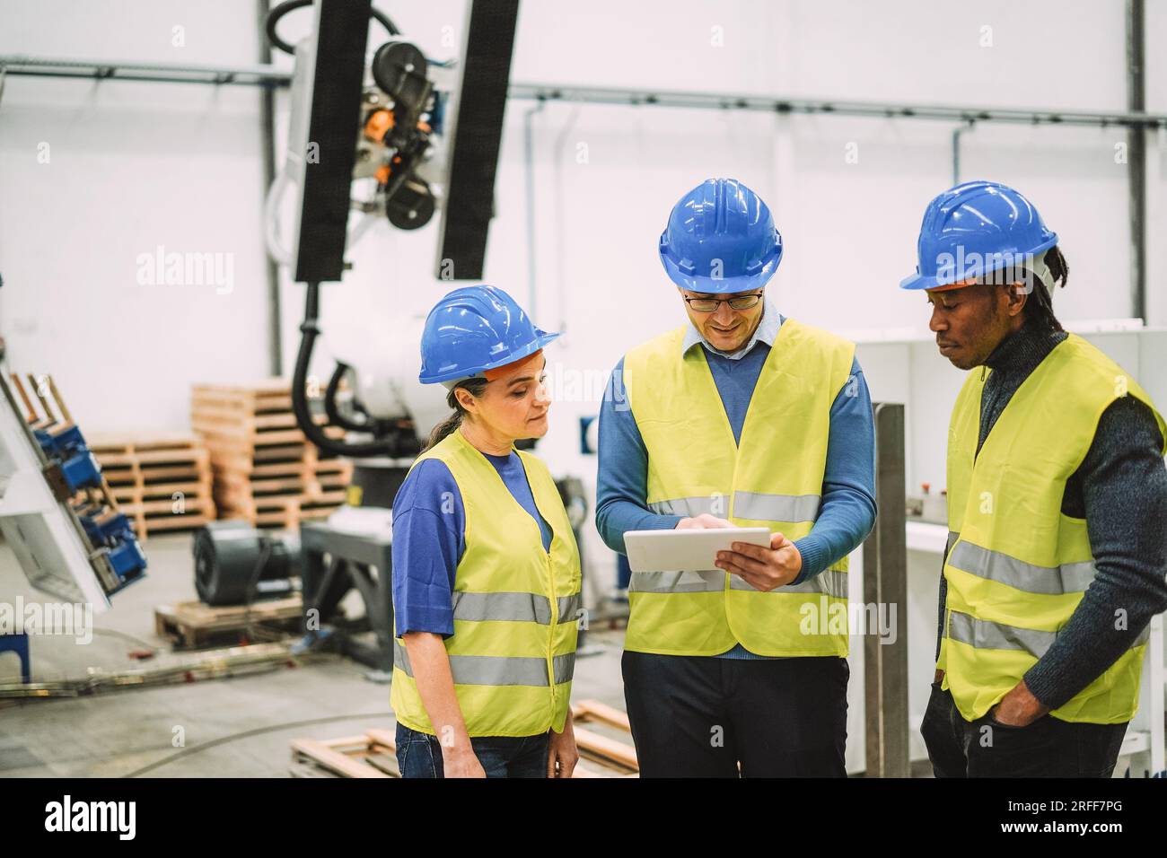 Engineers working at new AI prototype inside robotic factory Future