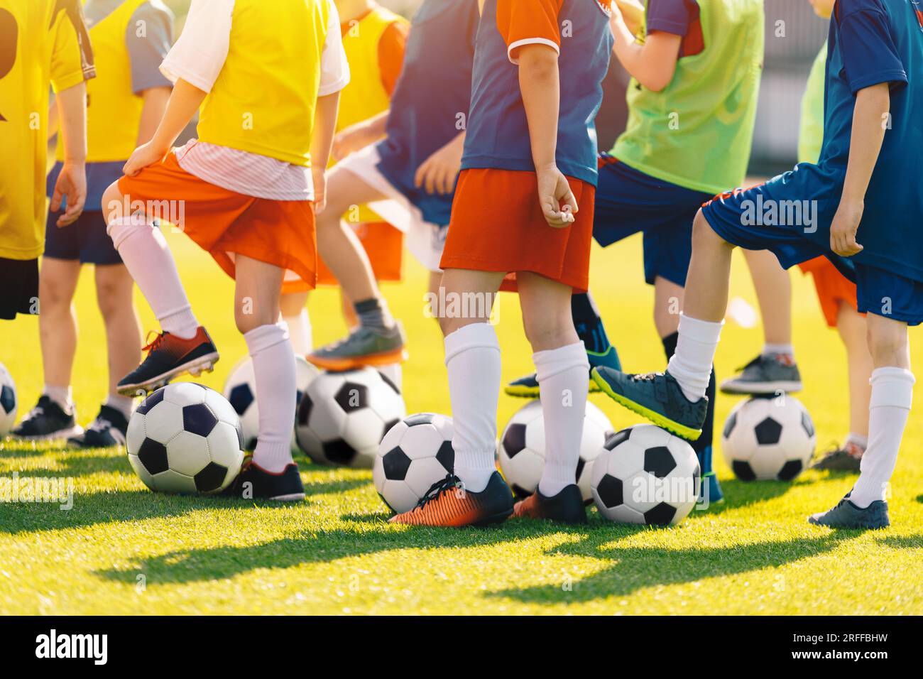 Group of Children With Football Soccer Balls at Training Class. Outdoor Football Training For Little School Kids. Boys and Girls Having Fun at Sports Stock Photo