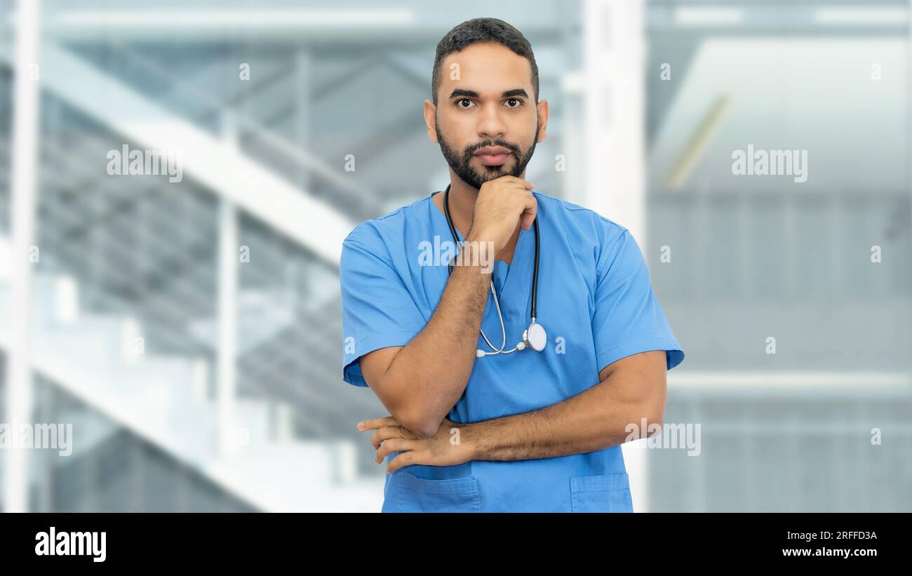 Handsome mexican male nurse or doctor with beard and stethoscope at clinic Stock Photo