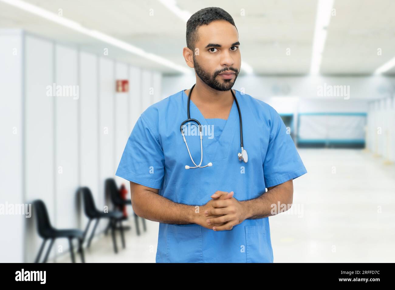 Handsome hispanic male nurse or doctor at hospital Stock Photo