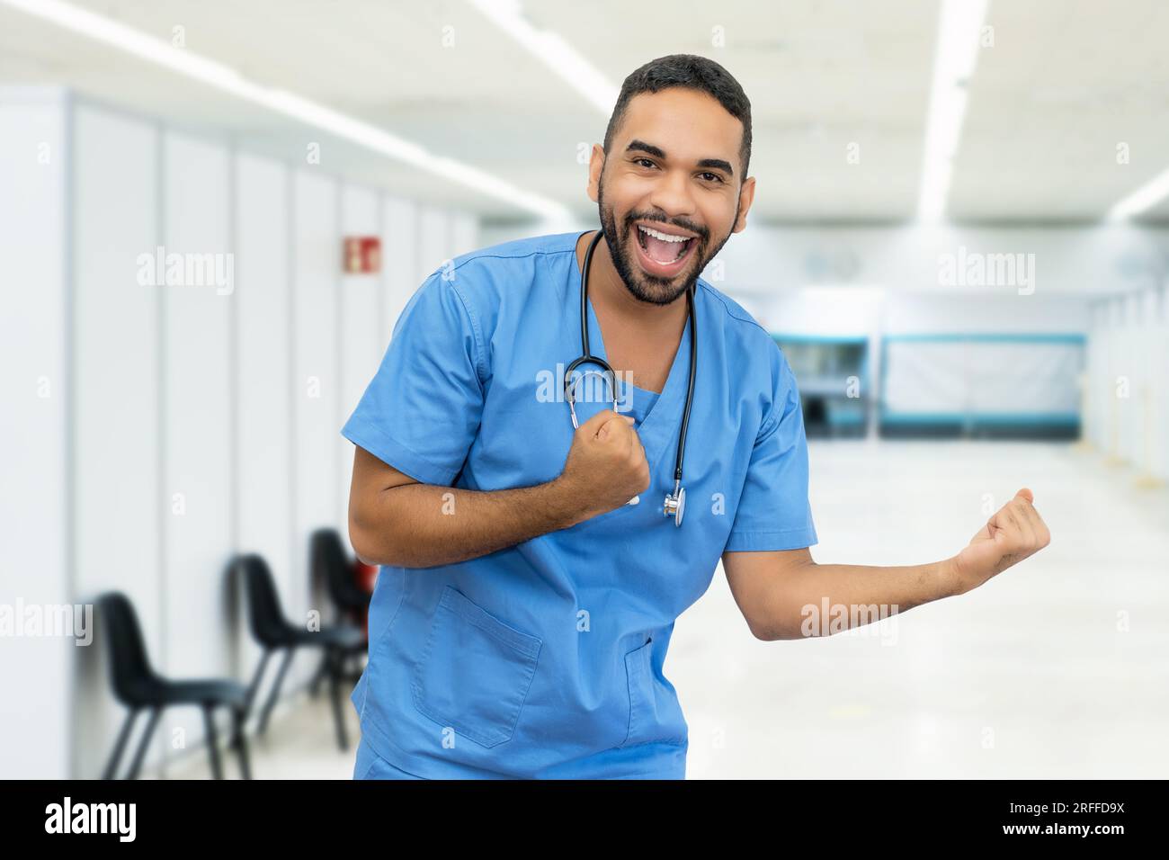 Cheering hispanic male nurse or doctor at hospital Stock Photo