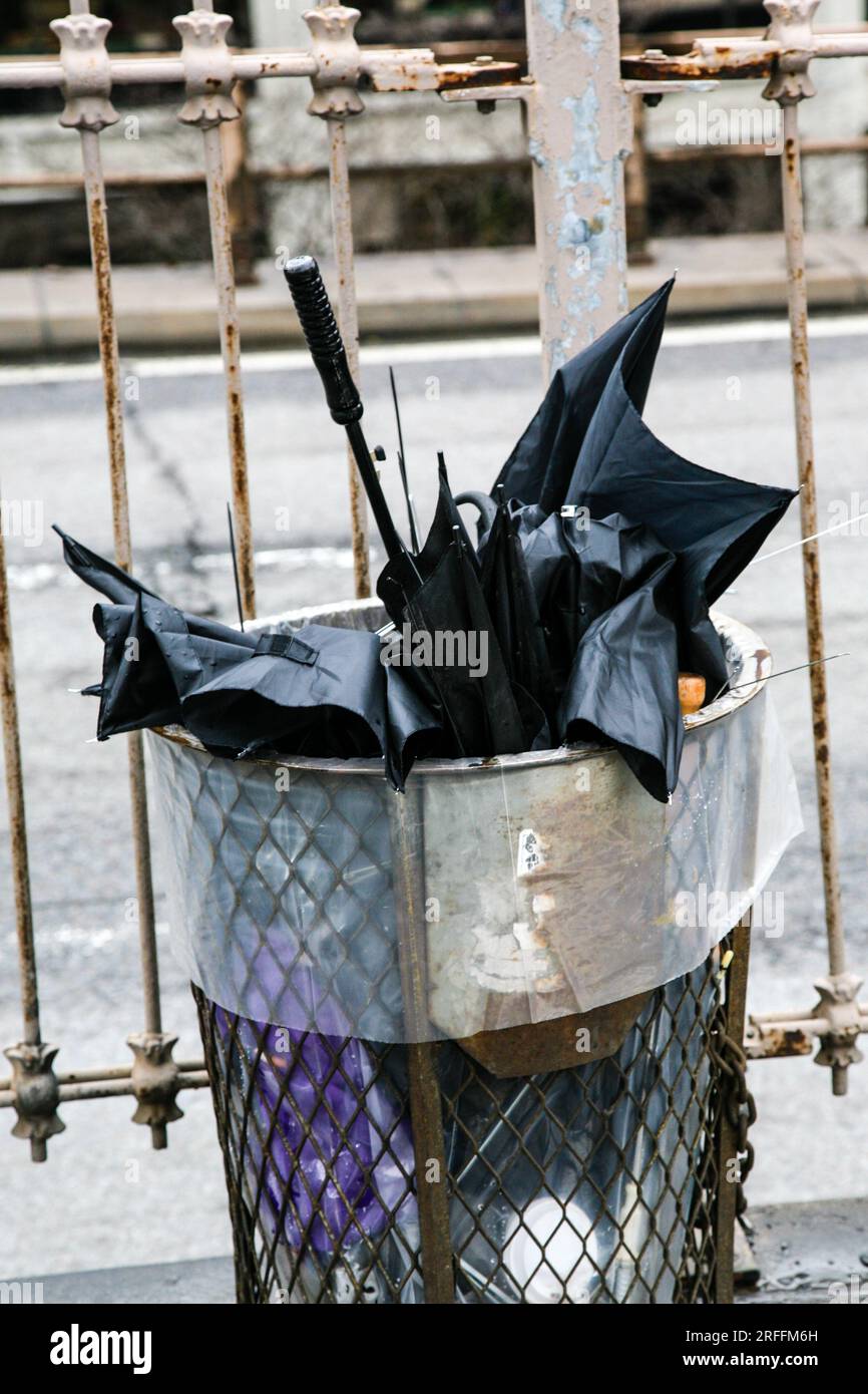 Damaged umbrella dumped in bin on a stormy day, New York City, USA Stock Photo