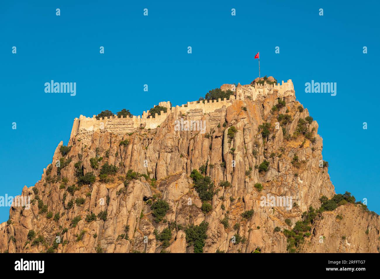 Afyon castle on the rock in Afyonkarahisar Turkey in front of a sunny blue sky Stock Photo