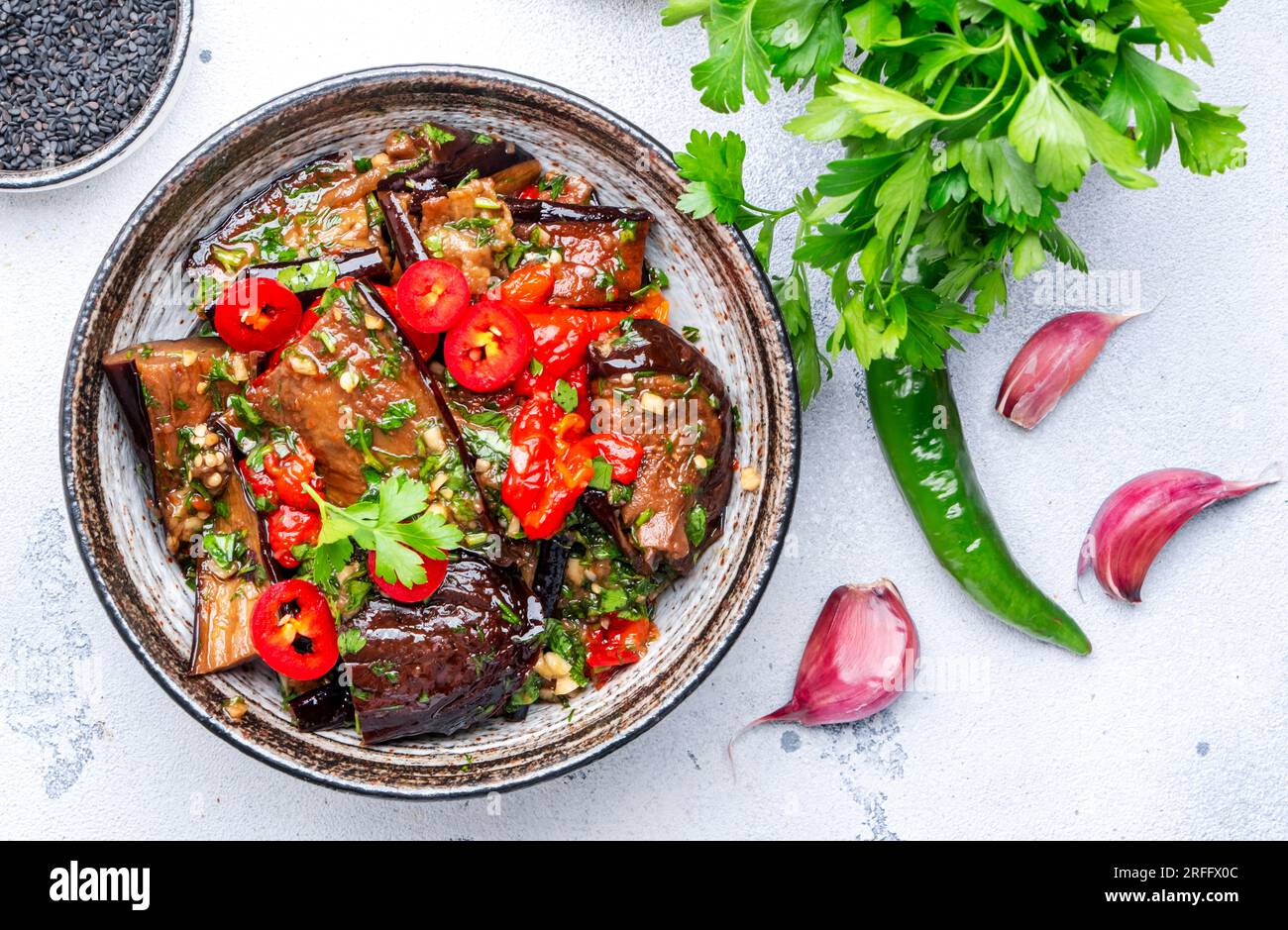 Marinated grilled eggplant with red chili peppers, parsley, sesame seed, soy sauce and garlic