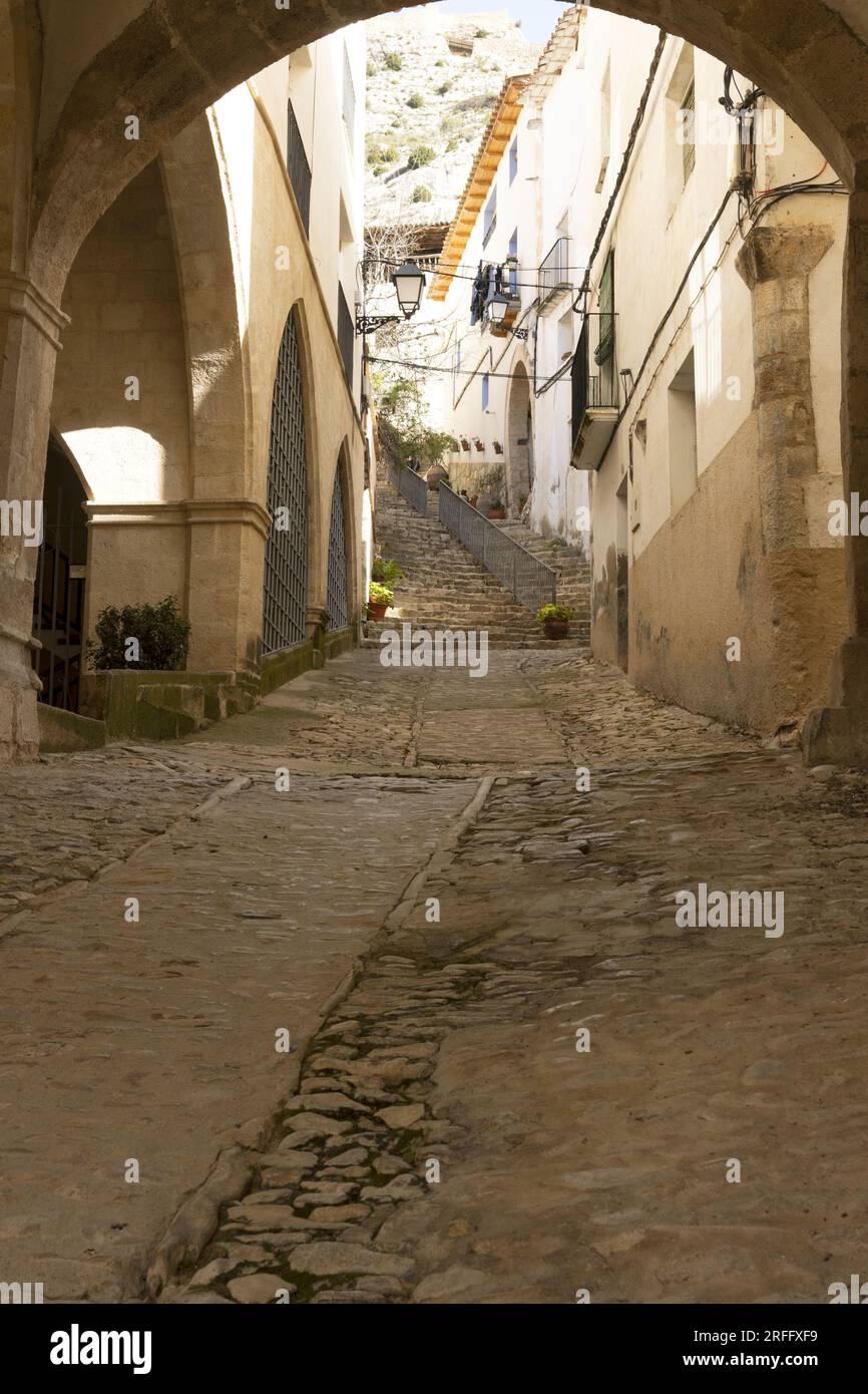 Beautiful architectural corner of Castellote, Teruel, Maestrazgo, Aragon, Spain, view of some old stairs from a semicircular arch, hdr photo Stock Photo