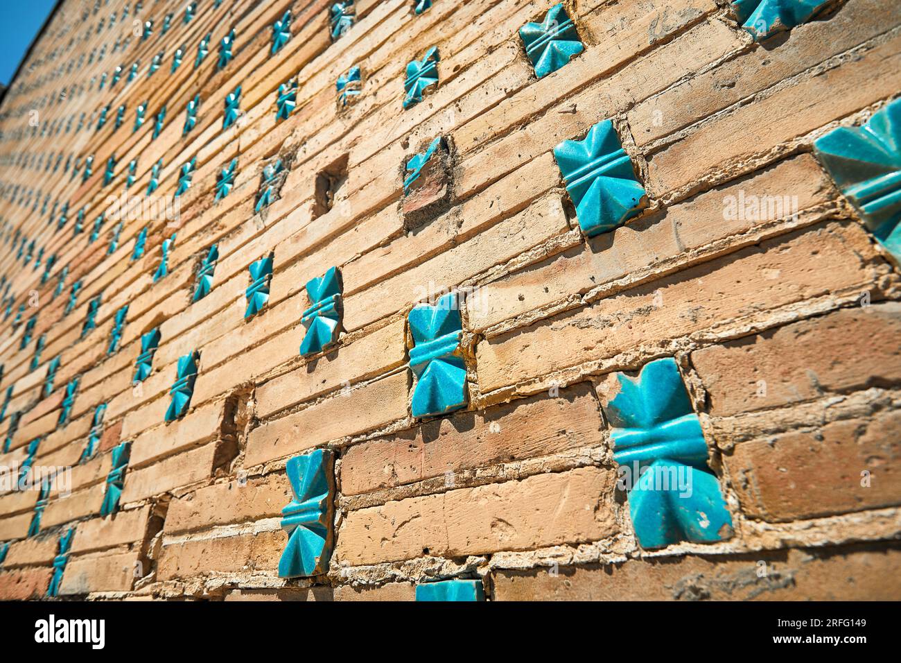 Wall with turquoise stone mosaic of beautiful Historical cemetery of Shahi Zinda mausoleums in Samarkand, Uzbekistan. Stock Photo