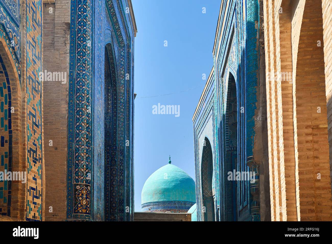 Beautiful Historical cemetery of Shahi Zinda entry Gate with finely decorated by blue and turquoise stone mosaic mausoleums in Samarkand, Uzbekistan. Stock Photo