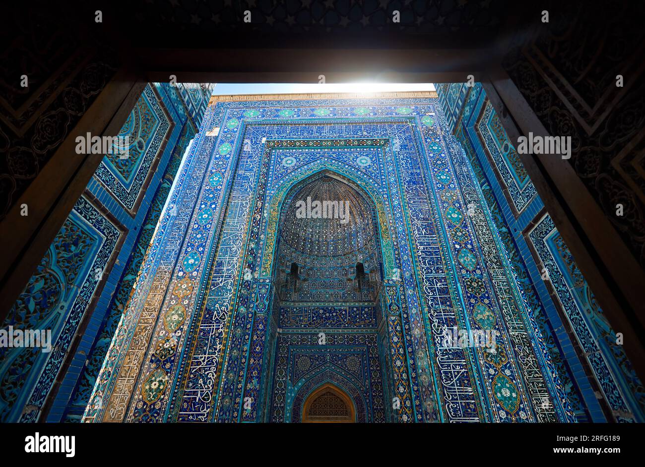 Beautiful Arch entrance of Historical cemetery of Shahi Zinda with finely decorated by blue and turquoise stone mosaic mausoleums in Samarkand, Uzbeki Stock Photo