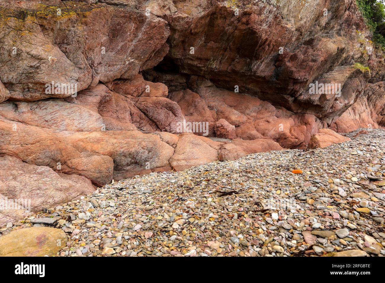 Red stones on the shore of the Atlantic Ocean Stock Photo