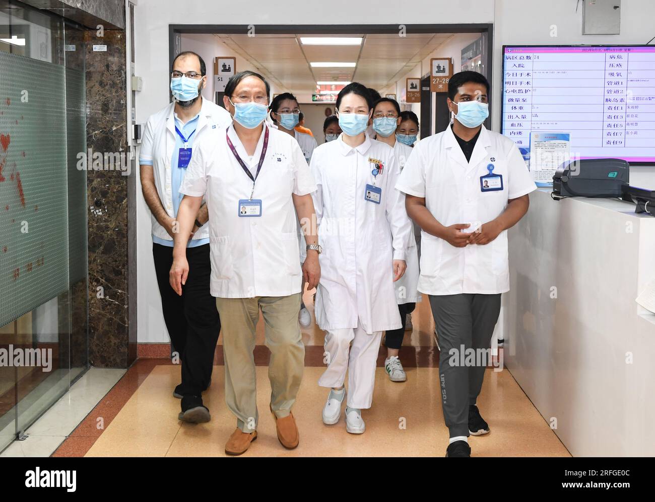 (230803) -- NANJING, Aug. 3, 2023 (Xinhua) -- Fan Zhining (L front), expert of digestive endoscopy, visits the inpatient wards with foreign medical workers of a medical seminar at Jiangsu Province Hospital in Nanjing, capital of east China's Jiangsu Province, Aug. 1, 2023. In recent years, Jiangsu Province Hospital cooperated with medical institutions in Pakistan, Egypt and other countries and regions in the field of digestive endoscopy to promote medical cooperation under the Belt and Road Initiative. (Xinhua/Ji Chunpeng) Stock Photo