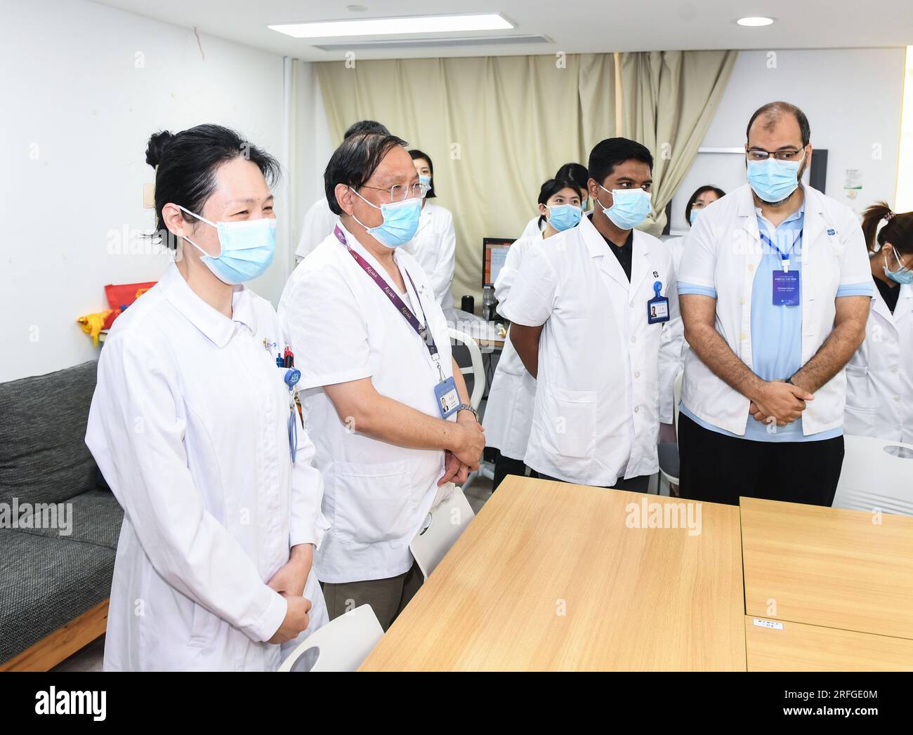 (230803) -- NANJING, Aug. 3, 2023 (Xinhua) -- Fan Zhining (2nd L), expert of digestive endoscopy, attends a morning session with foreign medical workers of a medical seminar at Jiangsu Province Hospital in Nanjing, capital of east China's Jiangsu Province, Aug. 1, 2023. In recent years, Jiangsu Province Hospital cooperated with medical institutions in Pakistan, Egypt and other countries and regions in the field of digestive endoscopy to promote medical cooperation under the Belt and Road Initiative. (Xinhua/Ji Chunpeng) Stock Photo