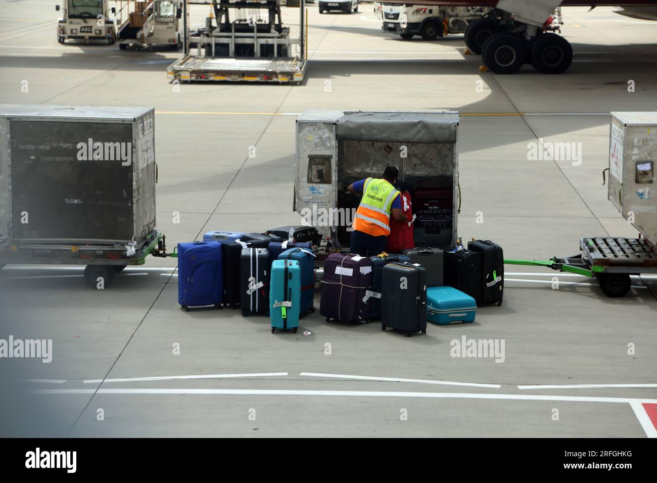 London Heathrow Airport England Baggage Handler Loading/Unloading Luggage Stock Photo