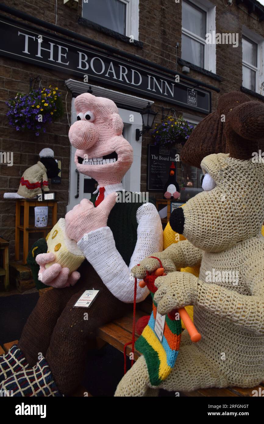 The Hawes Yarnbombers, local group of extreme knitters, Knitted figures of Wallace and Gromit with other characters from the series - Hawes Yorkshire Stock Photo
