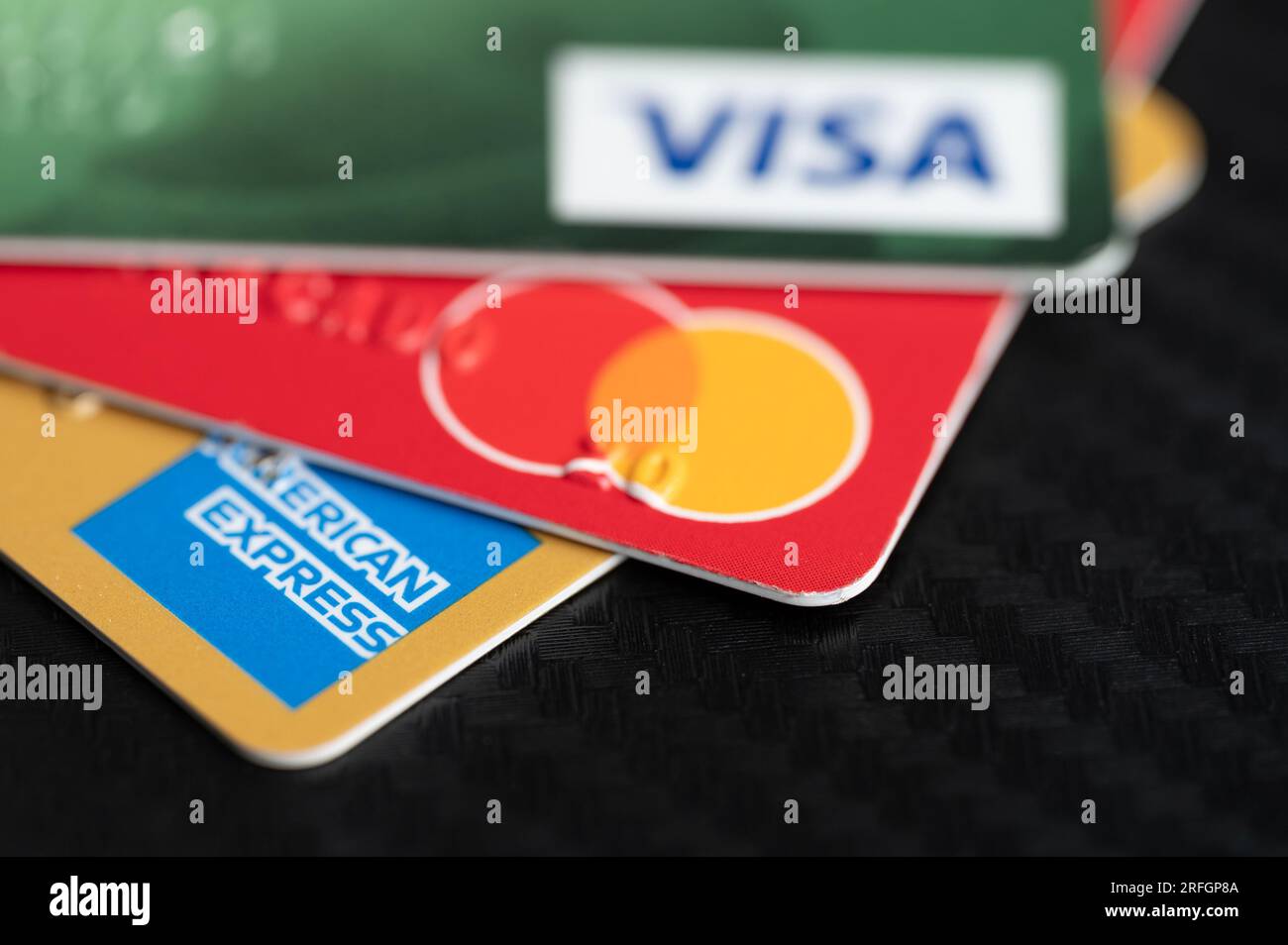 New York, USA - August 2, 2023: Different payment system cards macro close up view on table Stock Photo