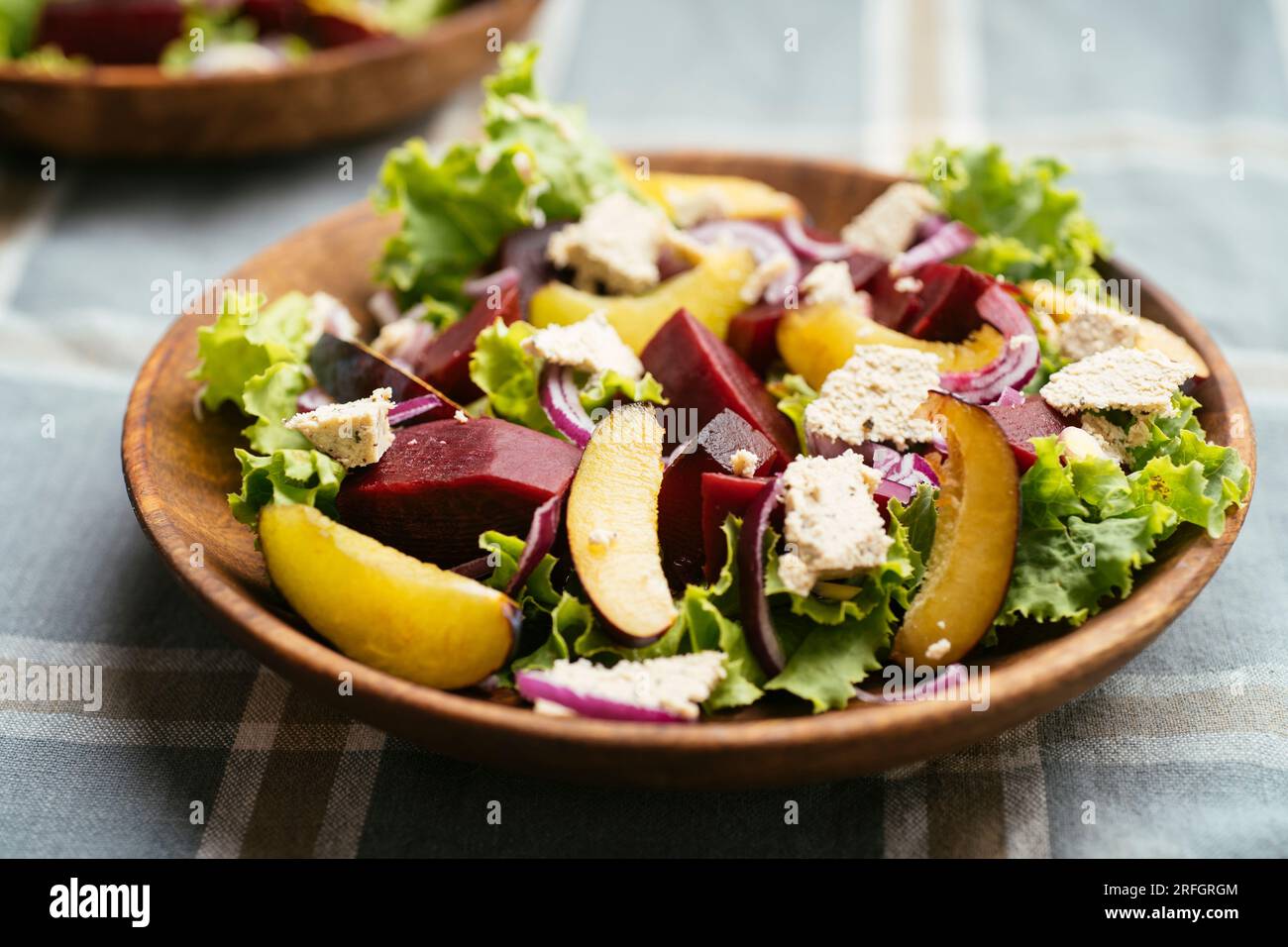 Home made salad with beets, plums and home made vegan feta. Stock Photo