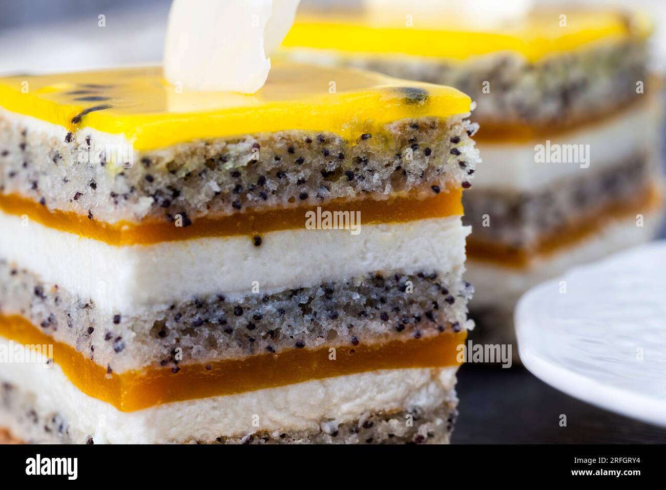 multi layered cake with cakes, fruit peach jelly, poppy seeds and