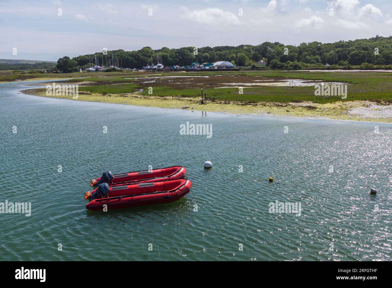 Two red dingies moored on the River Yar in Yarmouth, Isle of Wight, UK Stock Photo