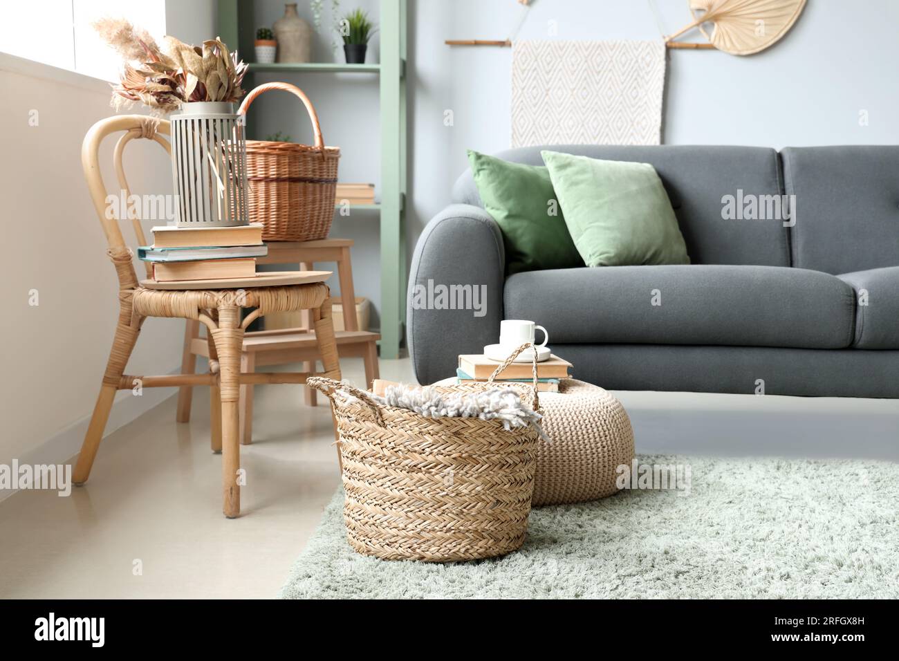 View of Interior of living room with sofa, wicker basket and chair Stock Photo ...