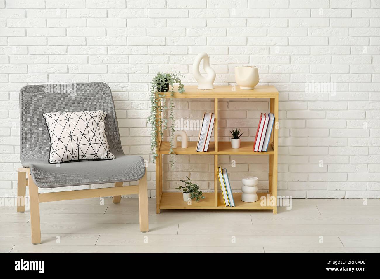 Interior of living room with bookshelf and chair Stock Photo - Alamy