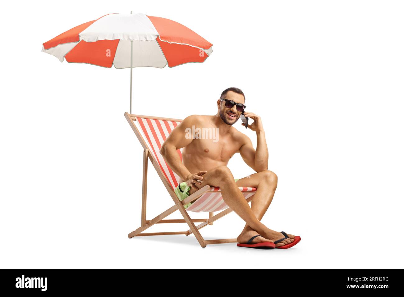 Man on a beach chair using a smartphone isolated on white background Stock Photo