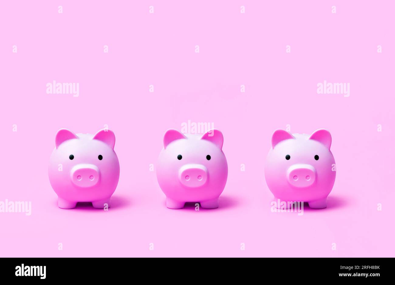 Pink color piggy bank on pink color background Stock Photo - Alamy