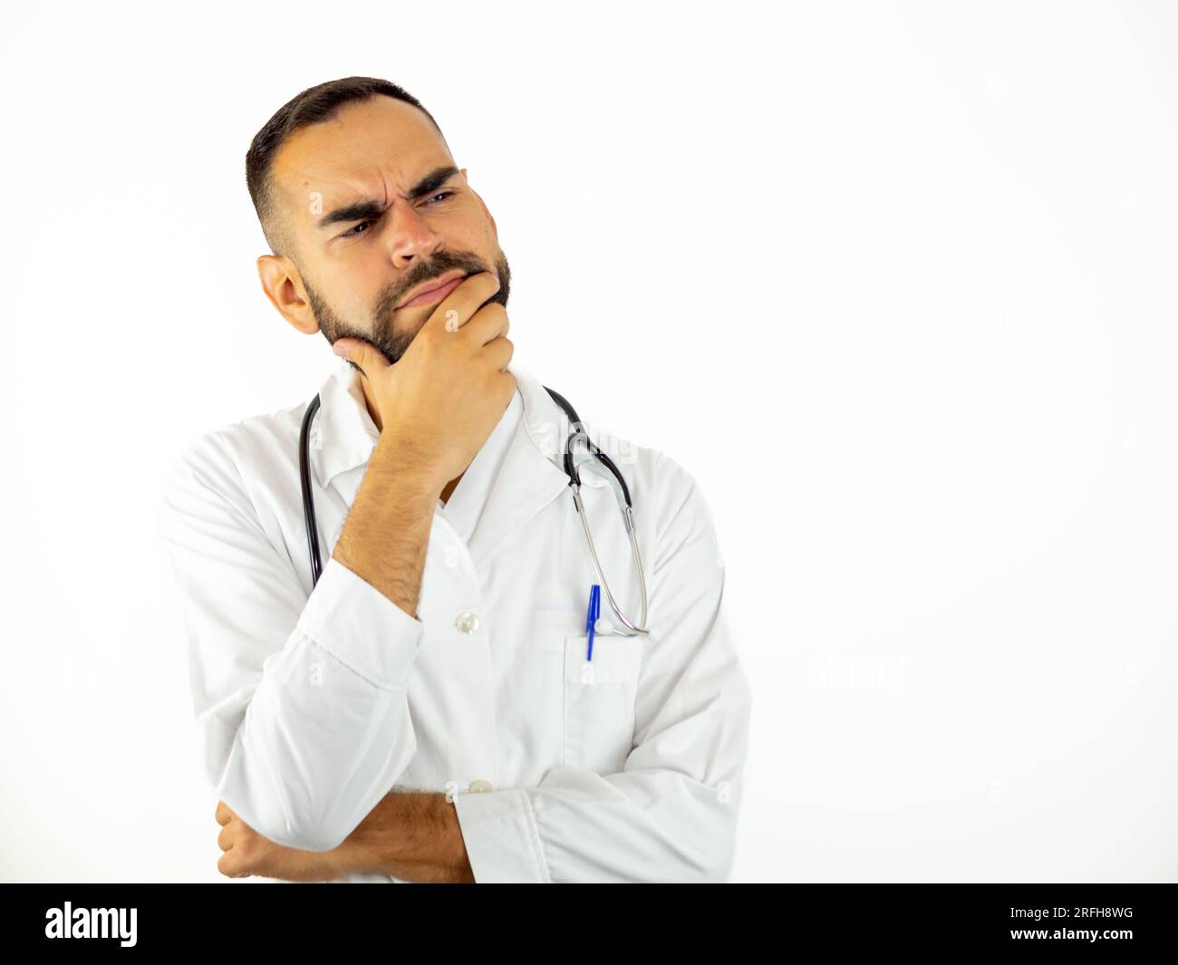 young-male-doctor-doubting-isolated-on-white-background-2RFH8WG.jpg